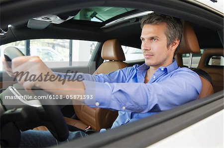 Mid adult man taking a test drive