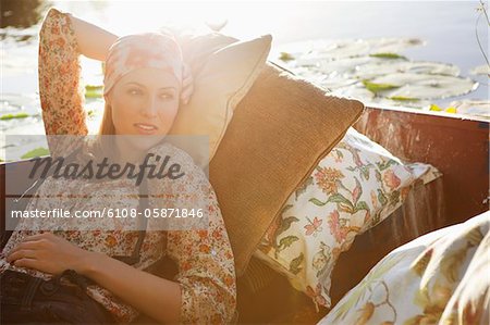 Beautiful woman day dreaming in the boat