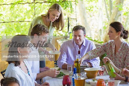 Multi generation family eating food at house