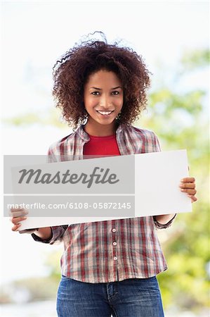 Portrait of a woman holding a blank placard