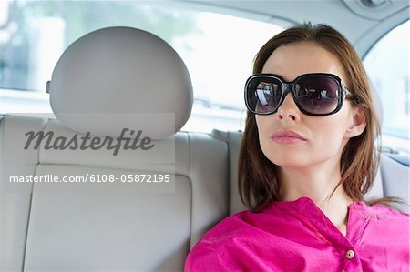 Beautiful young woman sitting in car