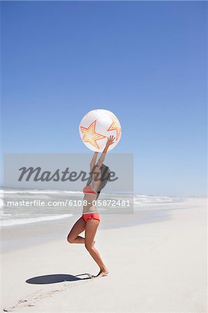 Woman playing with beach ball