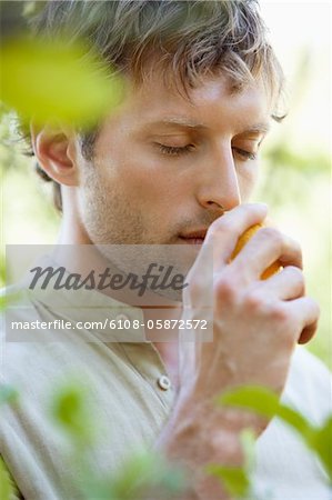 Close-up of a man smelling a lemon Close-up of a man smelling a lemon