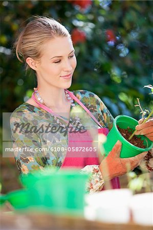 Young woman gardening and smiling