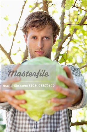 Portrait of a man holding a cabbage