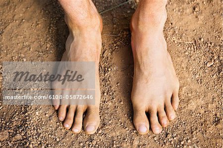 Low section view of a barefooted man
