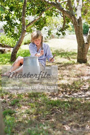 Little boy playing music on kitchen stuff