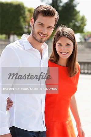 Couple walking with arms around and smiling, Paris, Ile-de-France, France