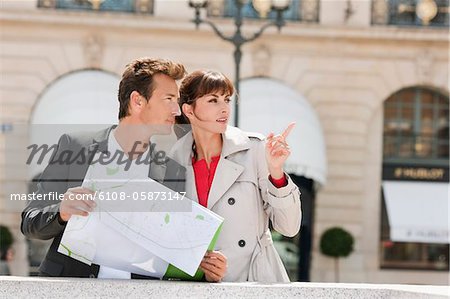 Couple reading a map, Paris, Ile-de-France, France