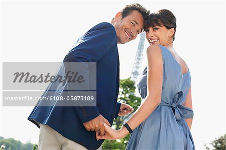 Couple with the Eiffel Tower in the background, Paris, Ile-de-France, France