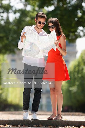 Couple reading a map in a garden, Terrasse De l'Orangerie, Jardin des Tuileries, Paris, Ile-de-France, France