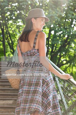 Woman standing on steps and smiling, Paris, Ile-de-France, France