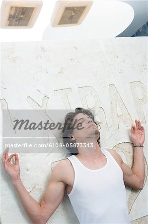 Man in yoga position, close eyes