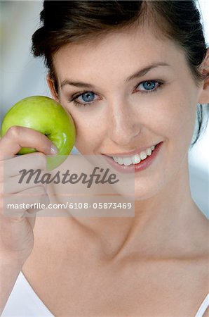 Portrait of a young woman eating an apple