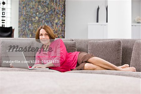 Woman working on a laptop and smiling