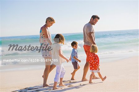 Famille marchant sur la plage