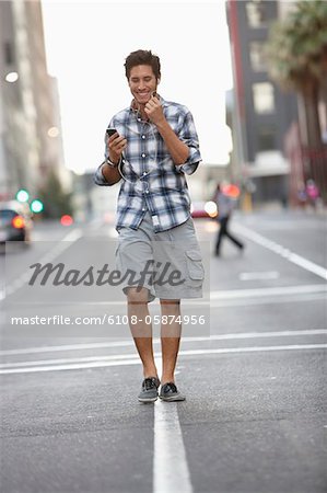 Man talking on a mobile phone while walking on the road