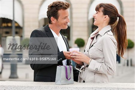 Woman giving a present to a man, Paris, Ile-de-France, France