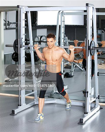 Handsome man at the gym doing exercises