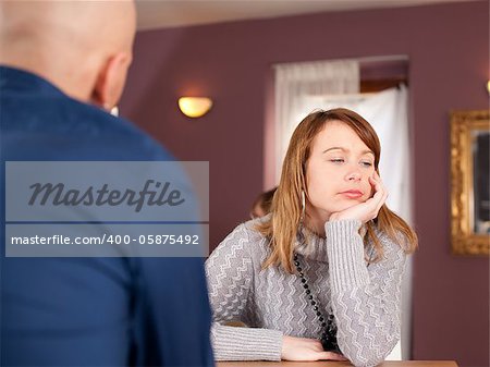 Distracted couple in cafe