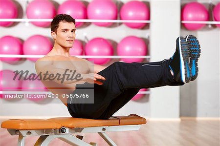 Handsome man at the gym doing exercises