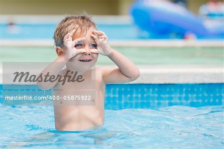 boy playing in a pool of water during the summer