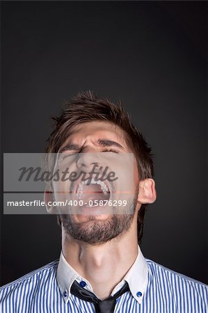 emotional business man man over gray background