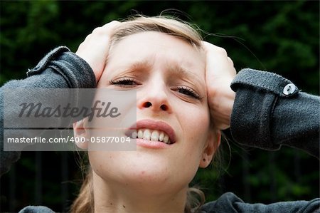 Young panic woman with hands on the head