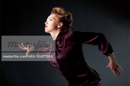 Modern fashionable woman posing over gray background