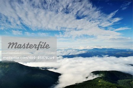 Landscape with mountains under morning sky with clouds