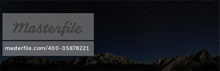 Starry night sky above rocky cliffs. Natural stars panorama photo