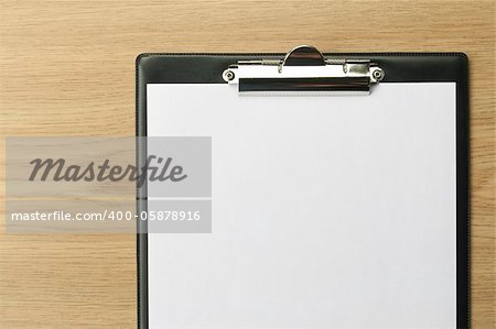 Clipboard with blank paper on office table