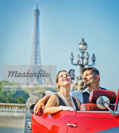 Romance in Paris. Young happy couple in retro-style travel in a car in Paris