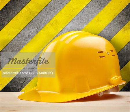 industrial concept with yellow hardhat, selective focus on nearest part