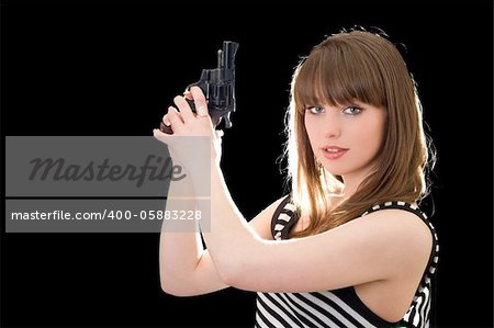 Beautiful young woman with pistol. Isolated on black