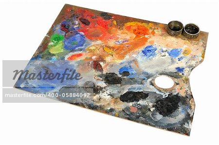 Artistic palette covered with colors on white background