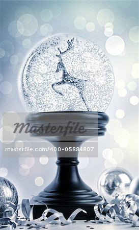 Snow-globe with ornaments against a festive background