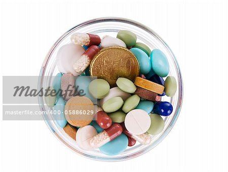 Fifty euro cents in glass saucer full of different pills on white background