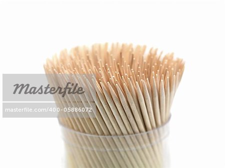 A close up shot of a wooden toothpicks on white