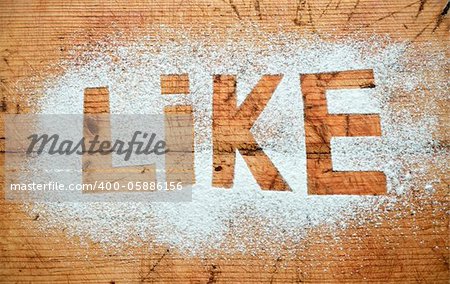 Like word on flour and wooden background