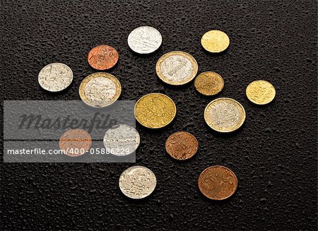 Coins on black wood background