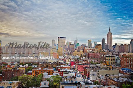 New York City skyline on a beautiful cloudy day. View of Lower West Side of Manhattan and Empire State building and Chrysler building.