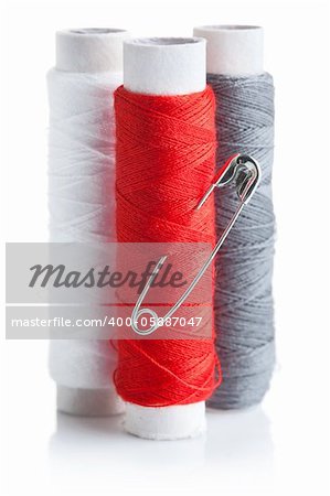 three skein of thread with pin isolated on white background