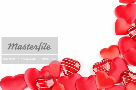 Frame made of various heart shaped decorations on white background