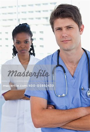 Portrait of professional doctors standing up in an office
