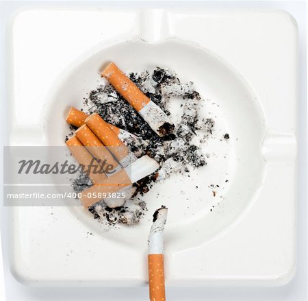 ashtray full of cigarettes on white