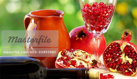pomegranate and glass of red wine