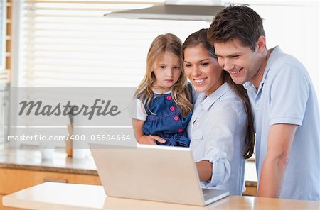 Family using a laptop in a kitchen