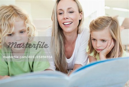 Mother reading magazine together with her children