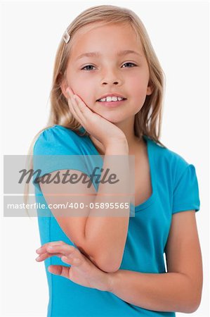 Portrait of a cute girl posing against a white background